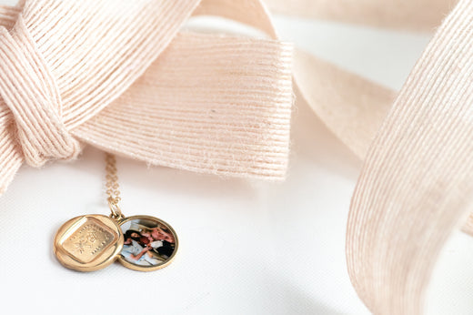 gold locket necklace with an image of a rose with a pink ribbon above